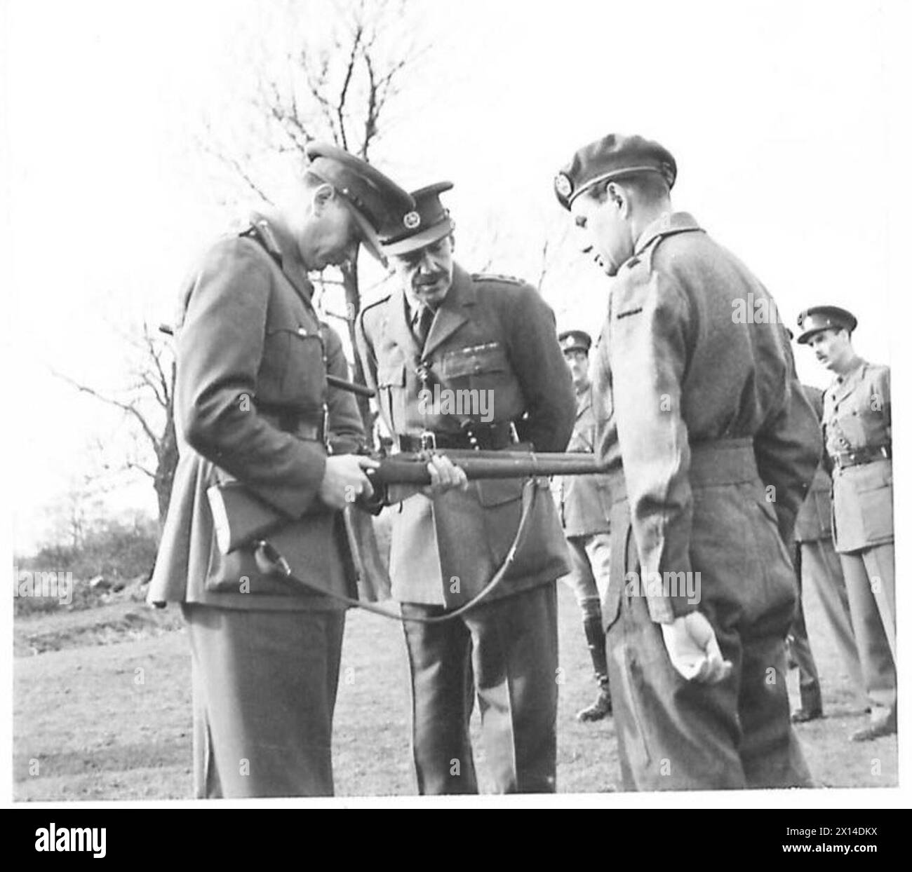 H.R.H. DUKE OF GLOUCESTER VISITS M.T. BATTALIONS IN NORTHERN COMMAND - HRH the Duke of Gloucester examining a new rifle (No.4) and trying the breech mechanism. In centre is Lt. Col. Sir Charles McGrigor, Bt. OBE British Army Stock Photo