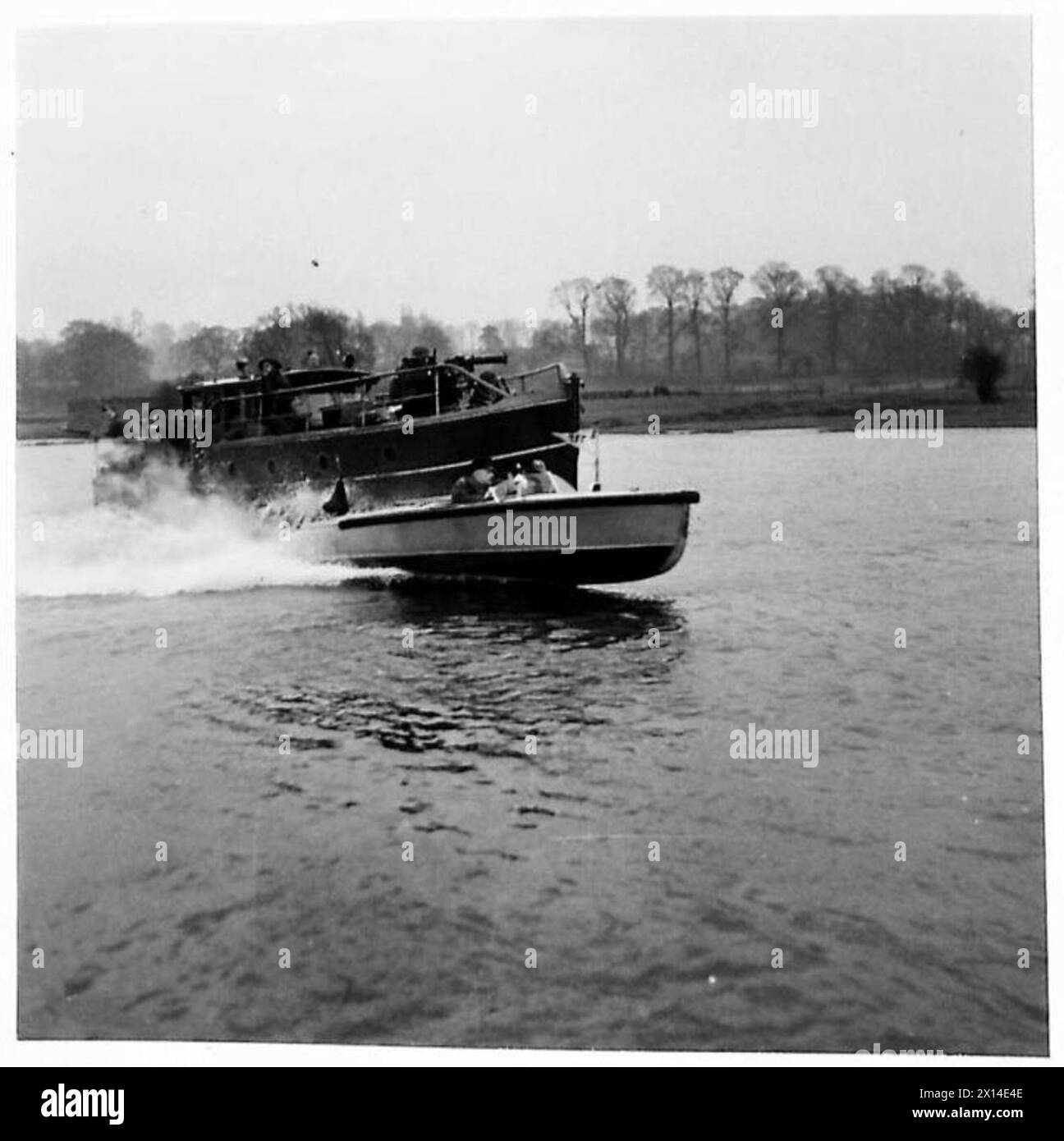 HOME GUARDS DEFEND INLAND WATERWAYS - Speedboats are used by the Trent River Patrol for collecting messages from the launches and rushing them back to H.Q. Here a speedboat crew are seen receiving a message from a launch and conveying it to H.Q British Army Stock Photo