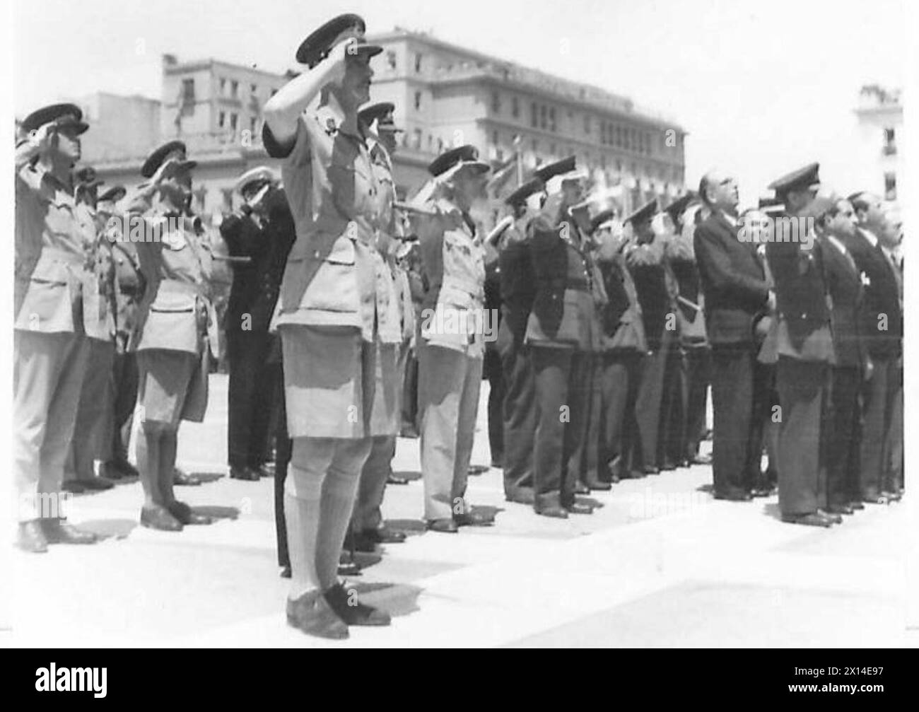 ATHENS CELEBRATES GERMAN CAPITULATION - Senior British officers salute as the National Anthem is played British Army Stock Photo