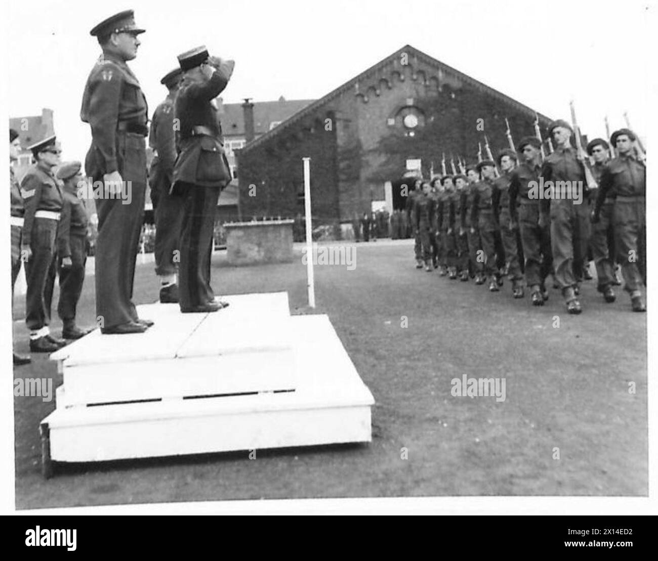 PRESENTATION OF CROIX PE GUERRE [613 REGT. R.A. , 37 R.H.U.] - A general view of the march past, in the picture Colonel Troullier is seen taking the salute and with him is the Commander of H.Q.l of C, General Surtees British Army, 21st Army Group Stock Photo