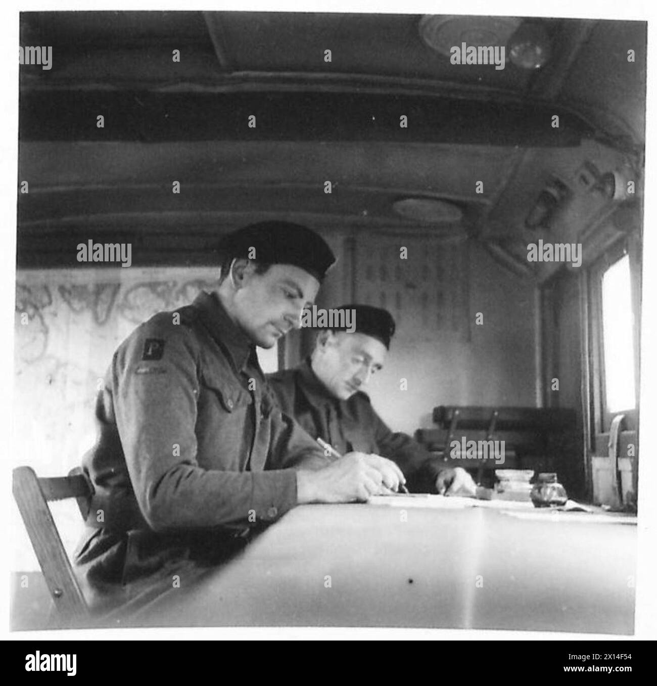 PHANTOM - Two telephonists, Sgmn. Clifton and Sgmn. Spalding who receive the messages fromthe Phantom Ops. tent They are in their vehicle at the C.O.R. of 2nd Army, which forms part of the Ops.Square British Army, 21st Army Group Stock Photo