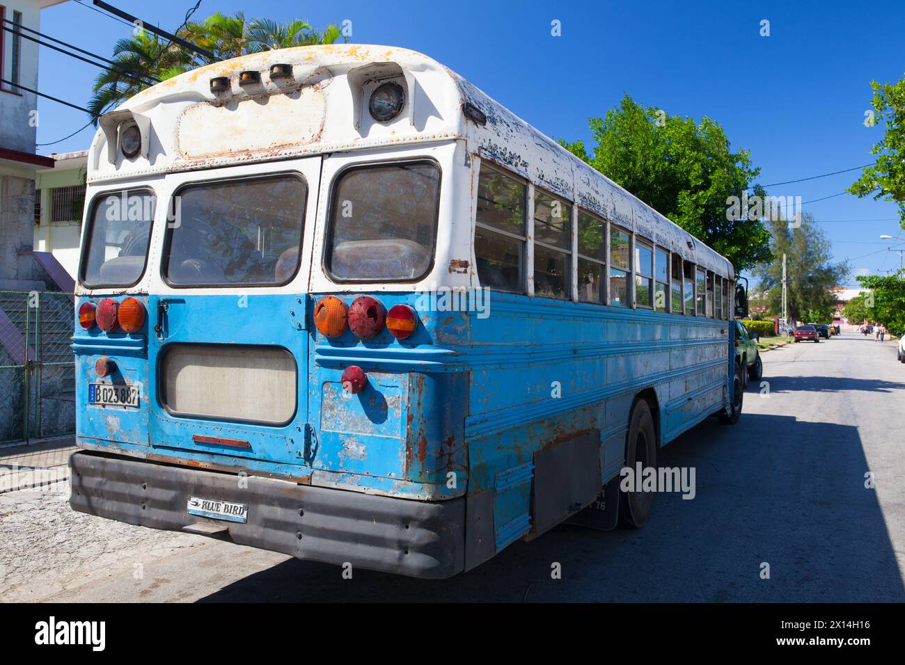 Havana, Cuba - January 2,2017: Typical old school bus parked in front of old building on the Havana street. Stock Photo