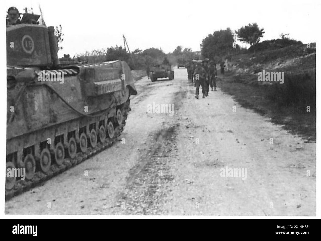 FIRST ARMY : JOINT ALLIED ATTACK ON PICHON - East of Pichon, Hampshires marching up the road behind the tanks (Churchill) British Army Stock Photo