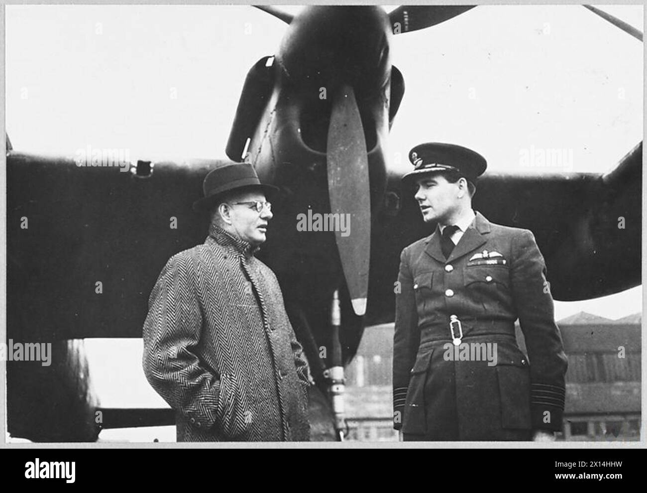 VETERAN LANCASTER BOMER 'G' FOR GEORGE PRESENTEDTO AUSTRALIAN PREMIER. - 13246. Picture (issued June 1944) shows - Australian Premier, Mr. John Curtin, is talking to Group Captain H.I. Edwards, VC.,DSO.,DFC., of Perth Australia, the Station Commander Royal Air Force Stock Photo
