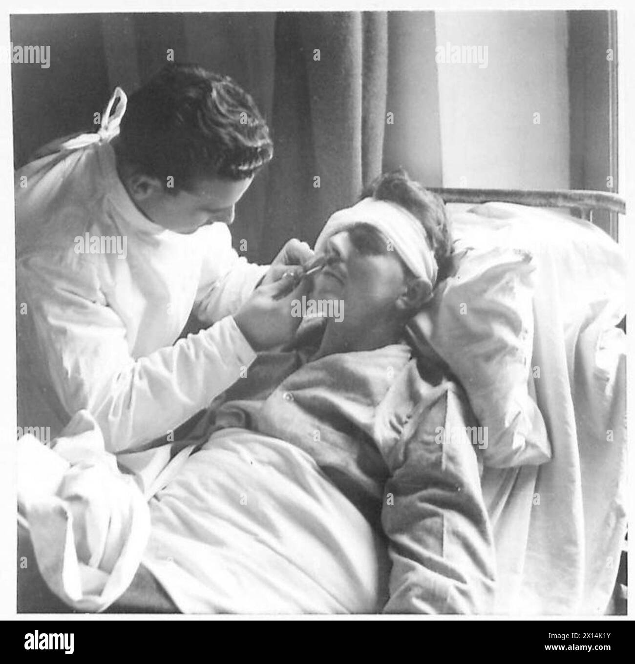 Front-line nurse 'Victor' trims Private Spinney's moustache while serving with the British Eighth Army in Italy. Stock Photo