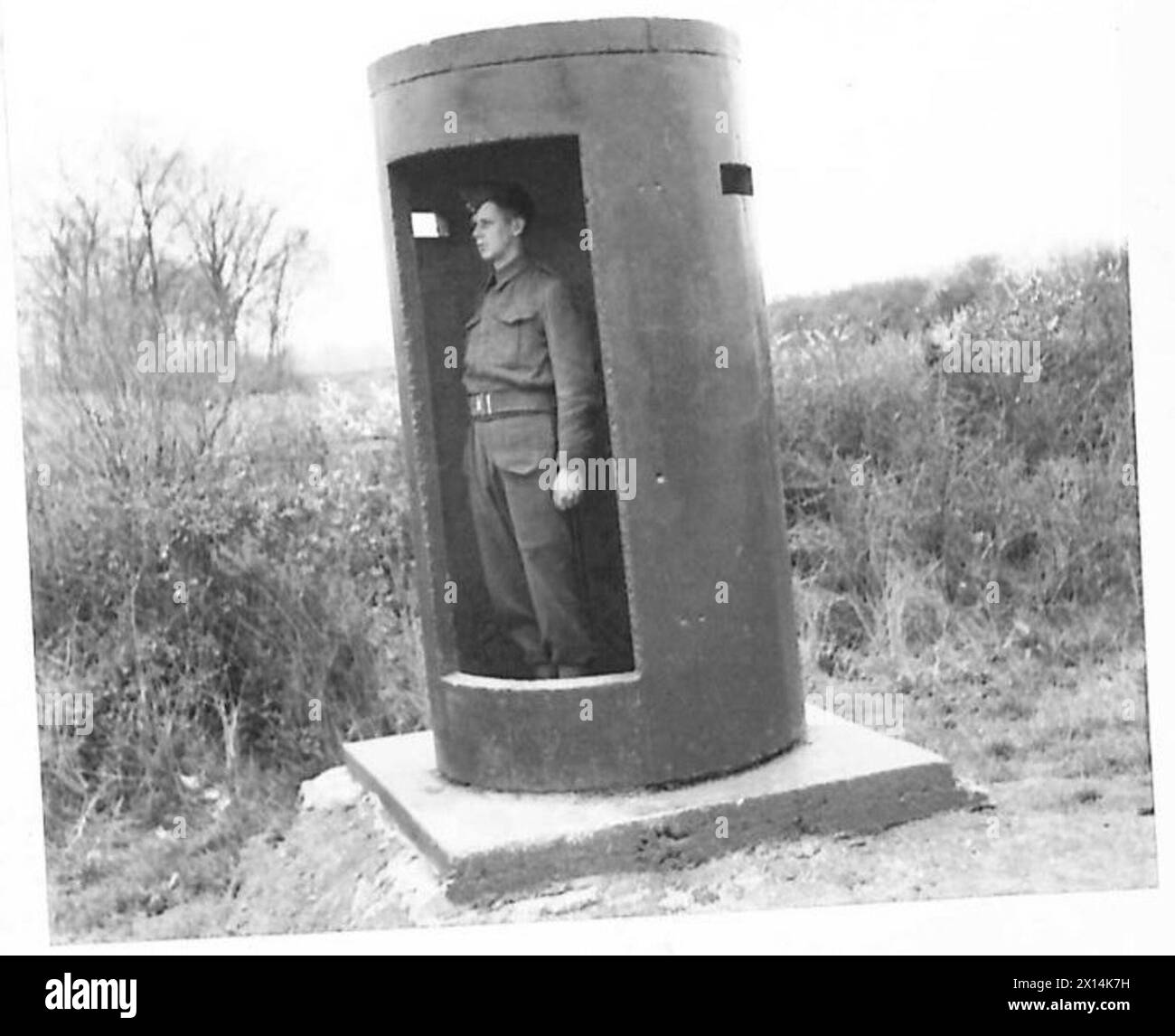 ROYAL ARMY ORDNANCE CORPS DEPOT - 'Drain pipe sentry box'. Large size concrete drainage pipes, for which no use can be found, are cut and converted into sentry boxes. Here a sentry is seen at his 'new' post British Army Stock Photo