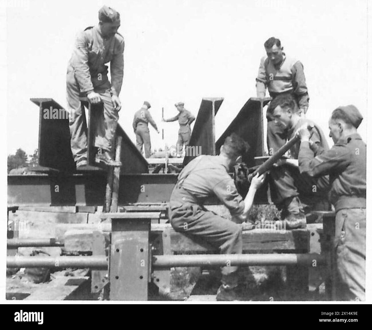 A MILITARY RAILWAY FOR TRAINING R.Es. - Iron girders of the jetty being bolted in postion British Army Stock Photo