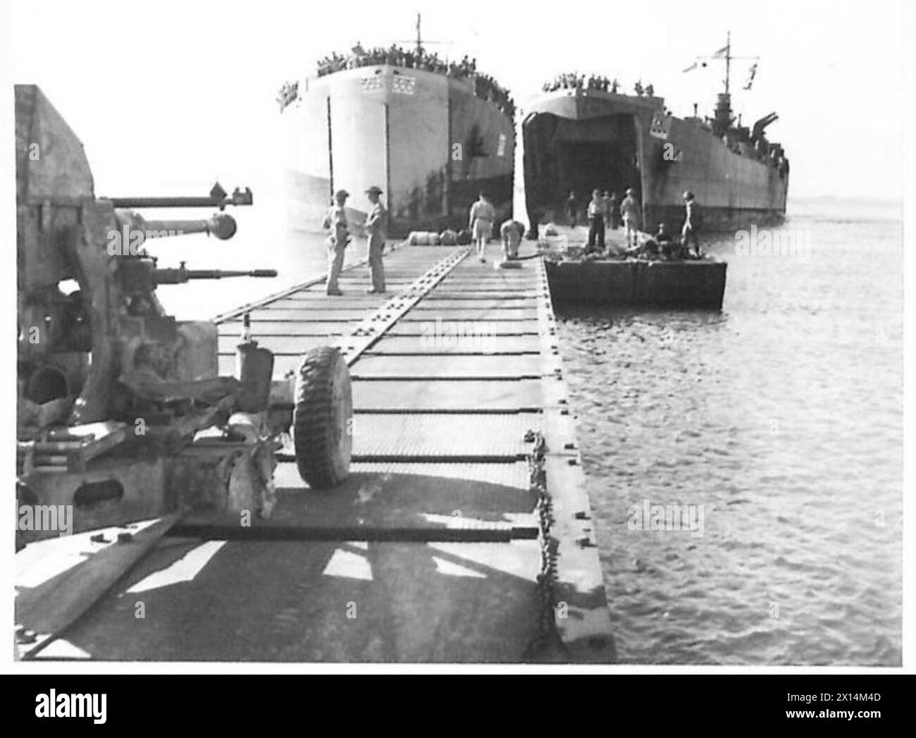 Landing craft unload troops and equipment on southern beaches as the ...
