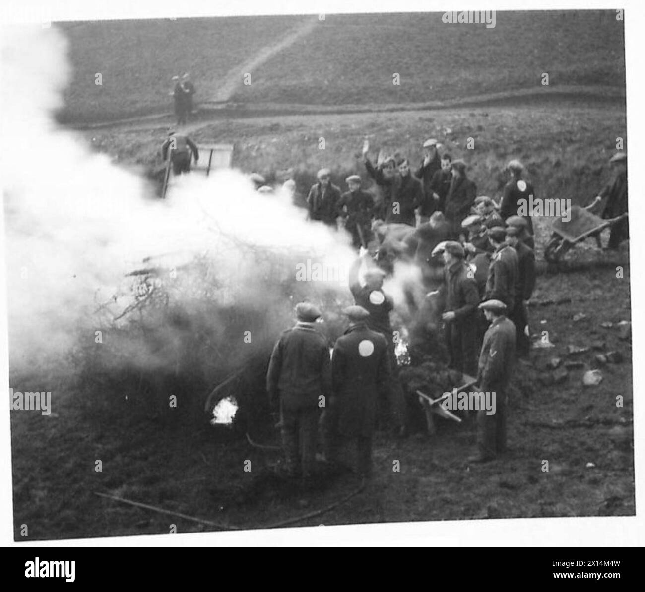 German prisoners-of-war perform gardening work at a POW camp under supervision during World War II. Stock Photo