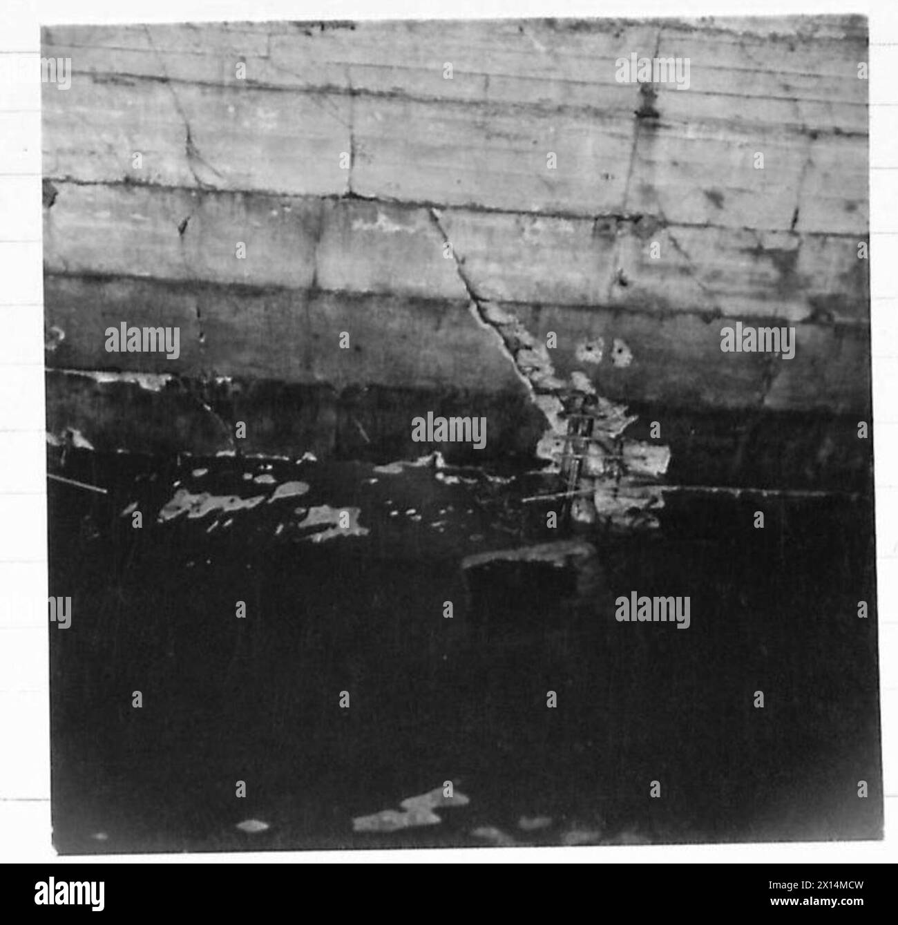 Photograph showing damage to a prefabricated breakwater unit at a port ...