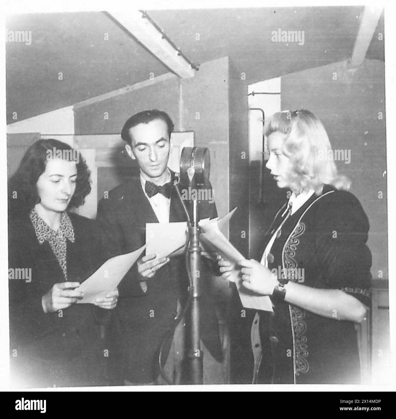 PWB BROADCASTING STATION AT KLAGENFURT - Fin.Kellner, Herr Lang, and Frau Doreig, on the air, a play is being read British Army Stock Photo