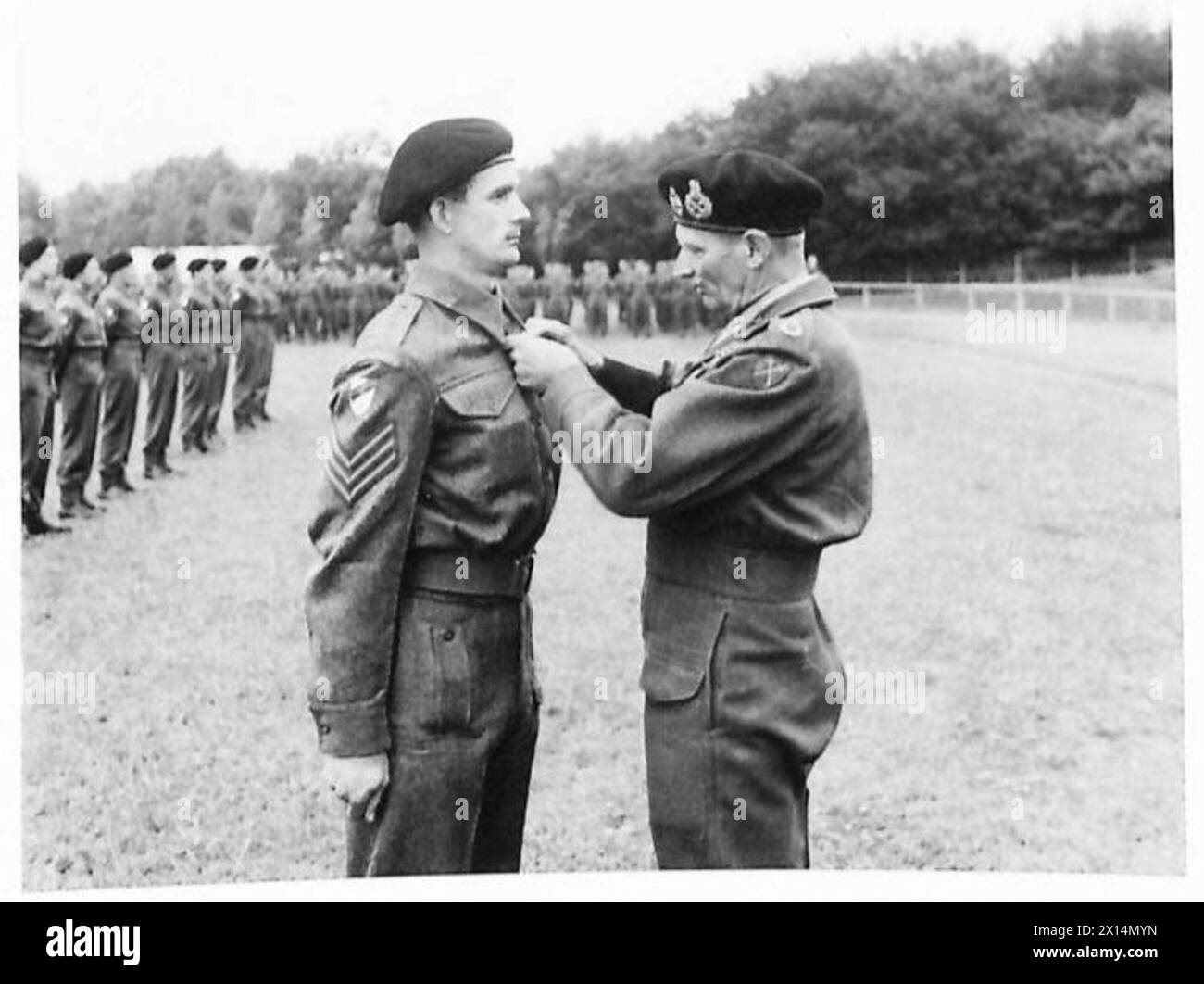 INVESTITURE CEREMONY FOR MEN OF THE 6TH GUARDS ARMOURED BRIGADE - Sergeant R.D.Thomson, 3rd Tk Scots Guards, receives the M.M. from the C-in-C British Army, 21st Army Group Stock Photo