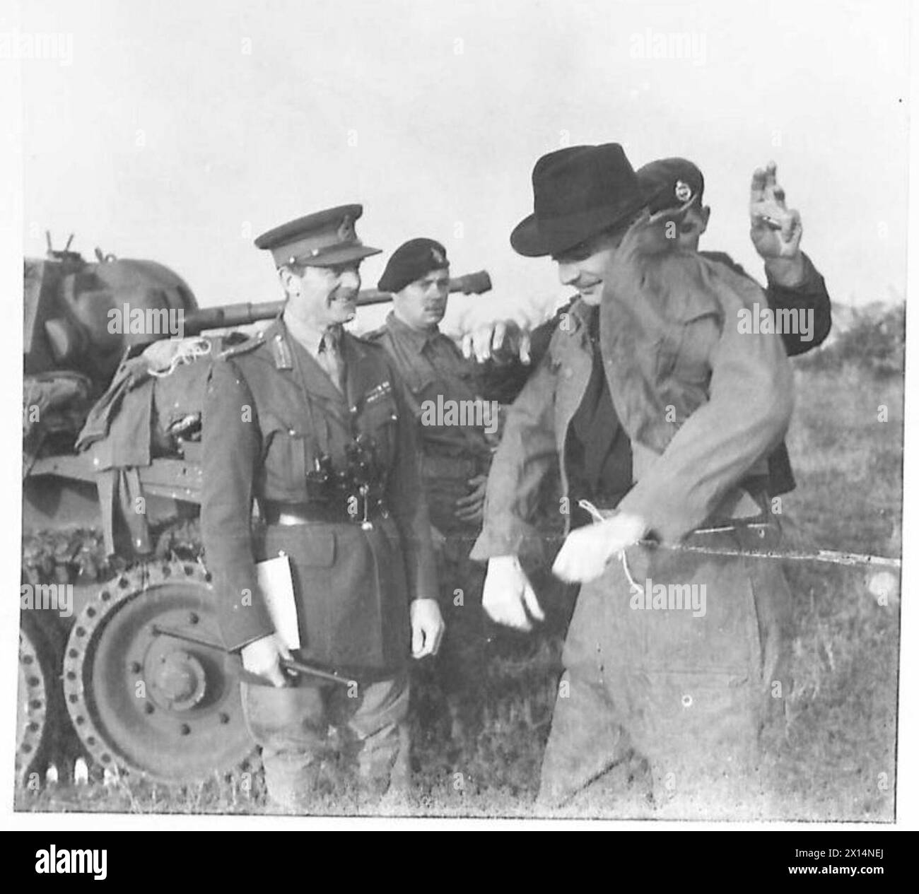 COMMANDER IN CHIEF FOLLOWS BIG EXERCISE IN TANK - Mr. Anthony Eden donning a battle dress overall before boarding one of the tanks British Army Stock Photo