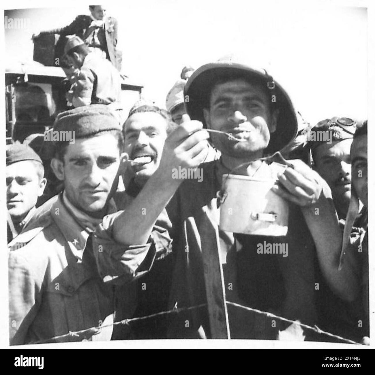 Italian prisoners at Gromalia camp in Tunisia consuming rations during ...