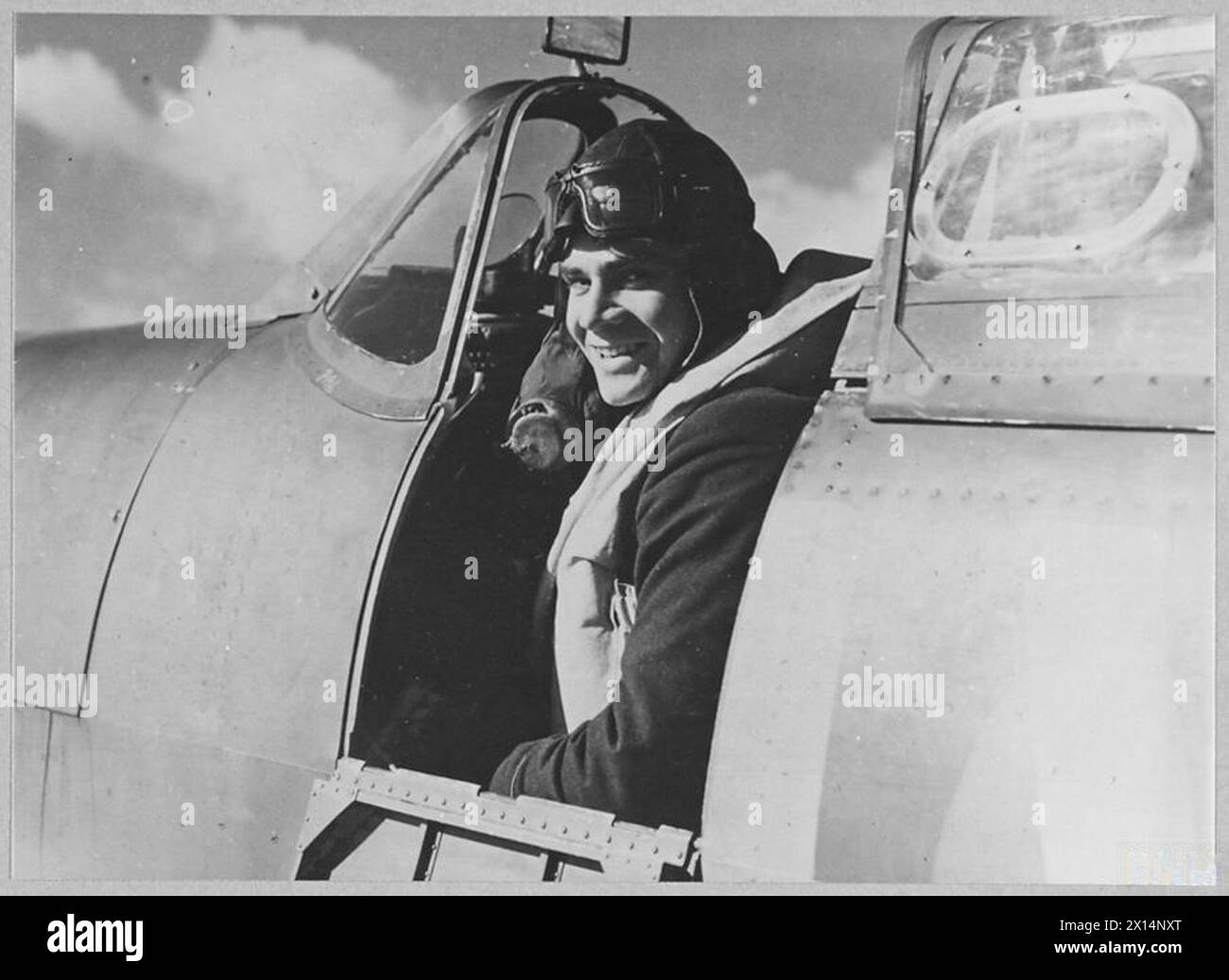 THE BATTLE OF BRITAIN 1940 - Flight Lieutenant Richard Jones smiles at the camera while seated in the cockpit of his Spitfire at Fowlmere, 21 September 1940 Royal Air Force Stock Photo