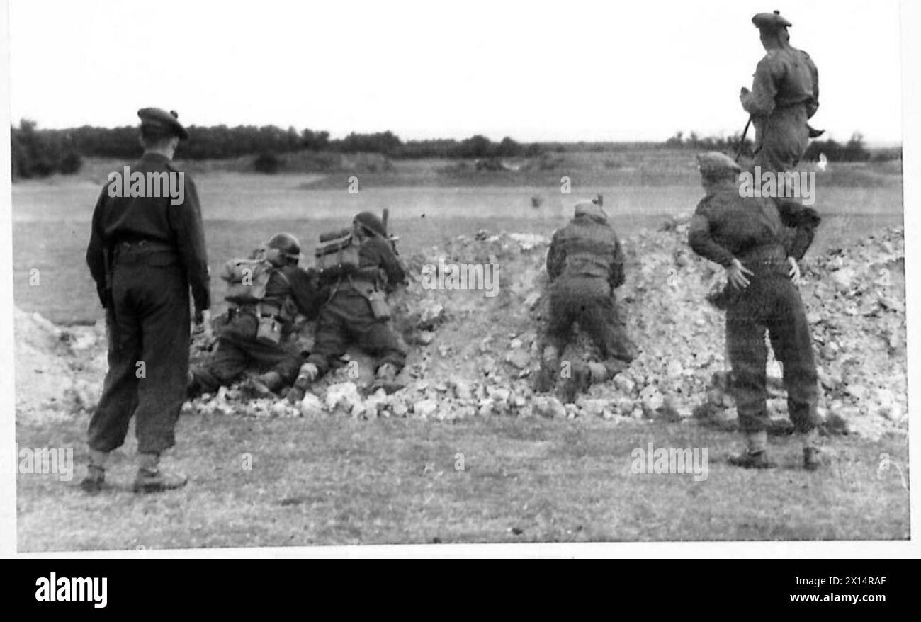 Royal Scots Fusiliers soldiers fire Bren guns at dummy tanks during a ...