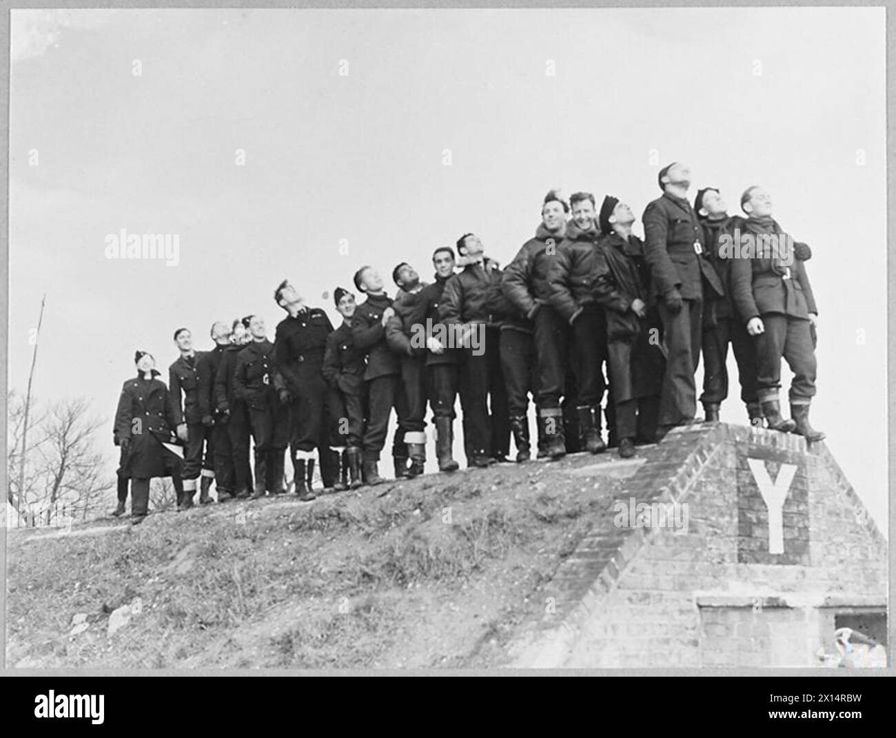 BRITAIN'S ACE FIGHTER PILOT TAKES OVER COMMANDOF A CRACK FIGHTER STATION - 8103 A critical audience of fighter pilots and mechanics watching Spitfires take off on a daylight sweep Royal Air Force Stock Photo
