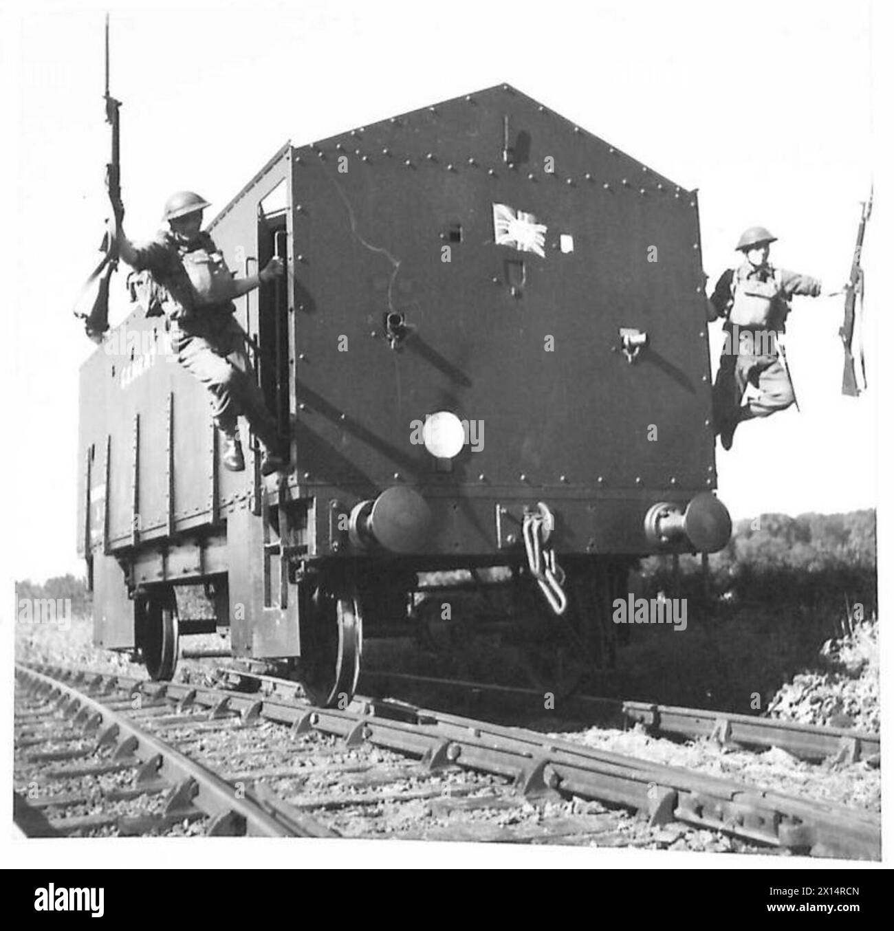 OFF THE TROLLEY AND INTO THE SCRAP - Troops leaping from an armoured rail trolley to contact the enemy who were though to be tampering with the permanent way British Army Stock Photo
