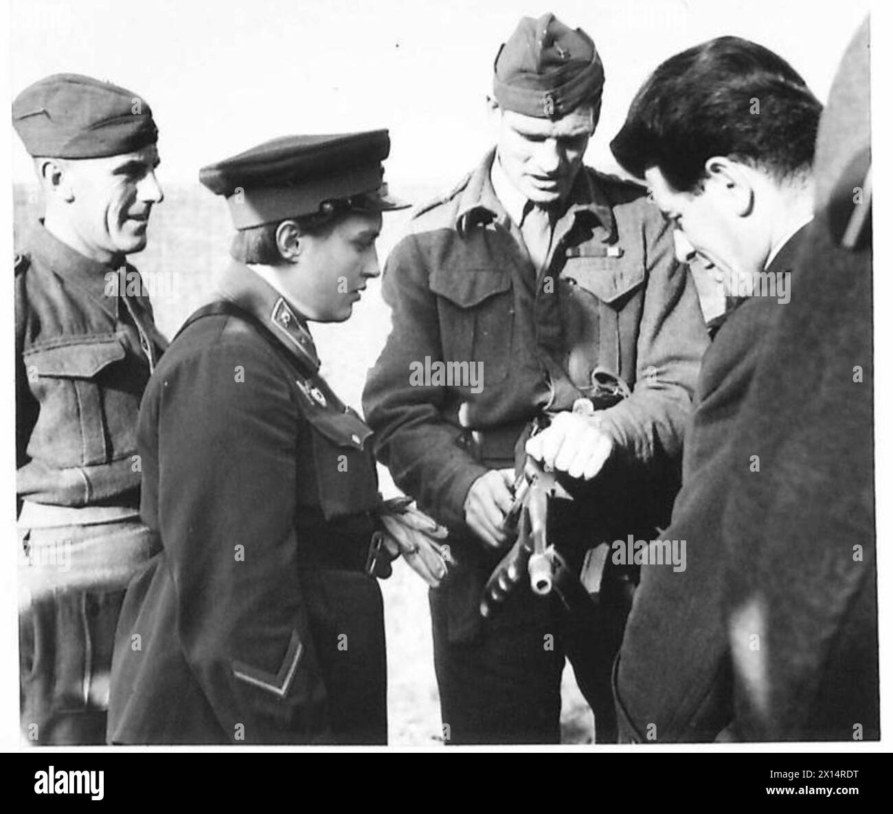 VISIT OF RUSSIAN DELEGATES TO CANTERBURY AND DOVER AREA - The officer in command explains the mechanism of a Tommy gun to Lt. Lyudmila Pavlichenko British Army Stock Photo
