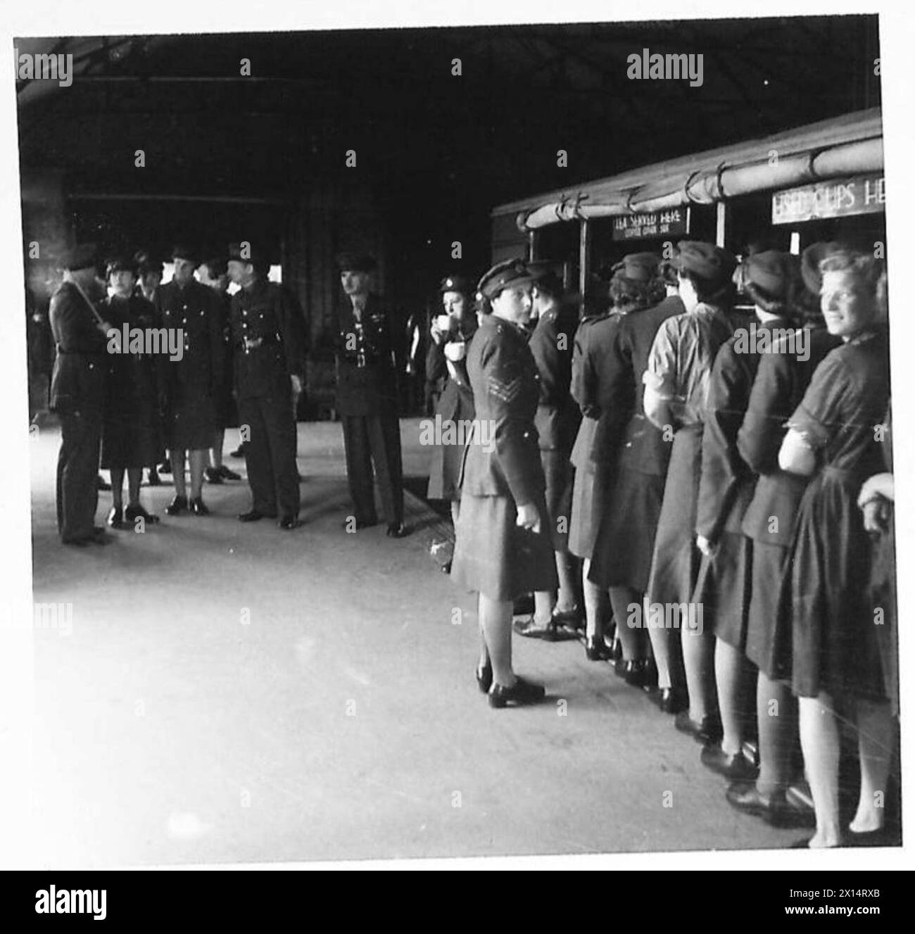 HRH THE PRINCESS ROYAL VISITS ORDNANCE DEPOTS - ATS auxiliaries lined up for tea at a mobile railway NAAFI are visited by HRH British Army Stock Photo