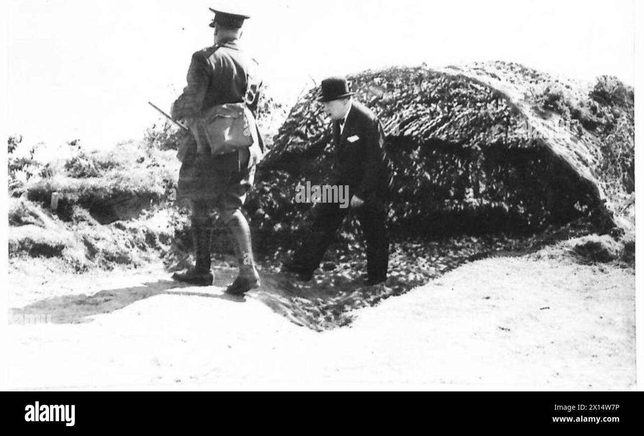 MR.WINSTON CHURCHILL VISITS THE NORTH EAST - Mr. Winston Churchill leaving a camouflaged tunnel leading down to a cliff-top strong point British Army Stock Photo