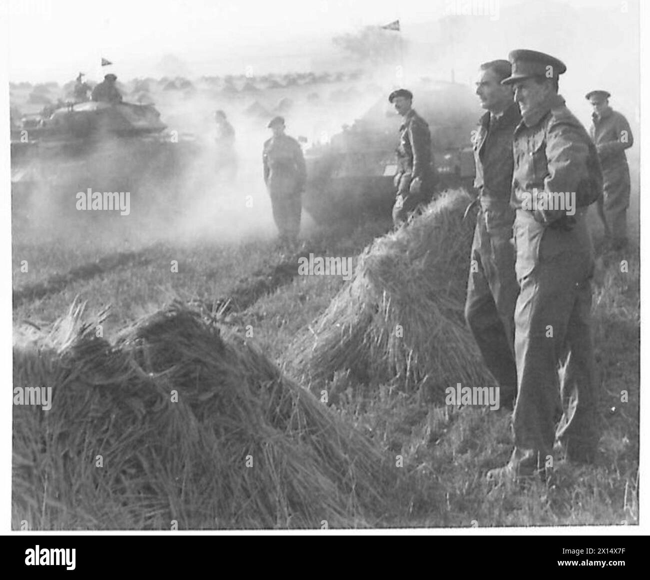 COMMANDER IN CHIEF FOLLOWS BIG EXERCISE IN TANK - General Sir Bernard Paget, with Mr. Anthony Eden, watching the tanks move off across a cornfield during the exercise British Army Stock Photo