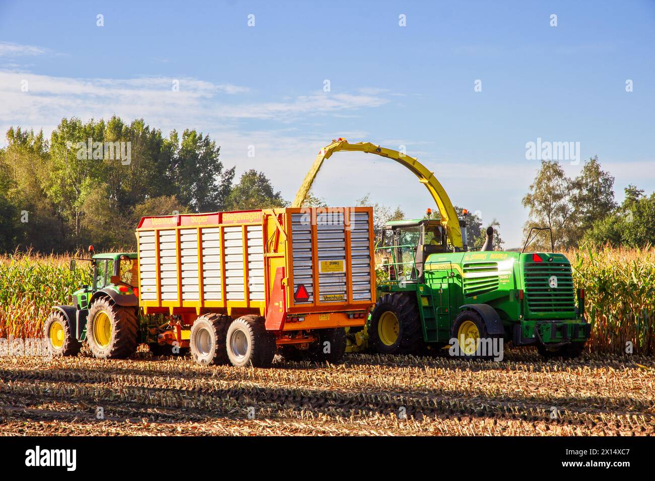 John Deere 6930 tractor and John Deere 7480i Forage Harvester at work. Achterhoek, Netherlands - Sep 19, 2016 Stock Photo