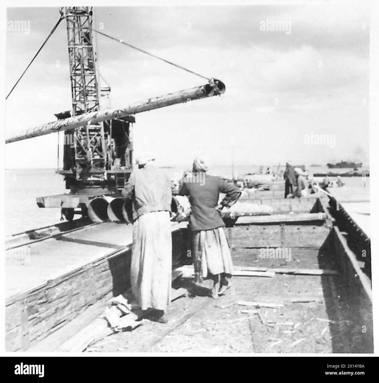 SUPPLIES FOR DESERT PIPELINE ARRIVE - Pipes being loaded on to a train for transport to the Desert. These are from America and will be used to extend the water pipeline which now extends for hundreds of miles into the Desert bringing water to our troops British Army Stock Photo