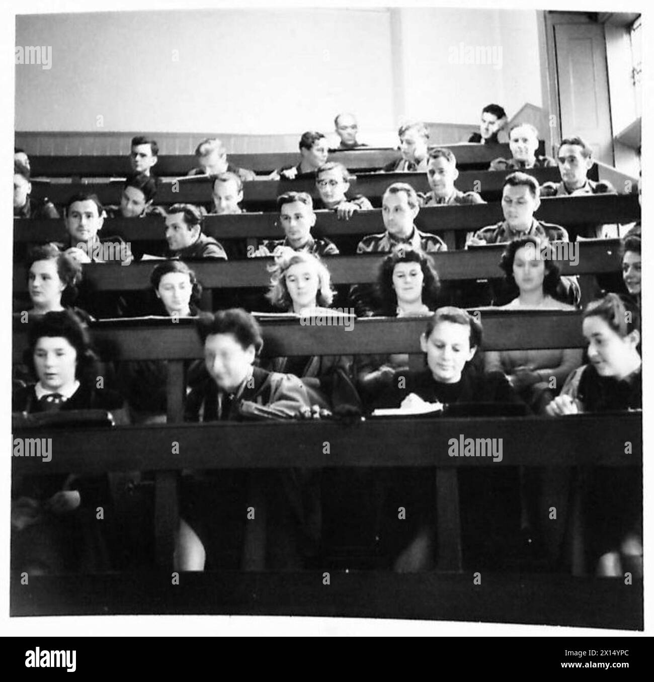 THE POLISH ARMY IN BRITAIN, 1940-1947 - Polish Army students taking a Economics lesson in a lecture room shared with female students. Professor Wright, the Dean of the Faculty at the University of St Andrews, offered General Marian Kukiel, the CO of the 1st Polish Corps, facilities for Polish Army students to continue their studies at the University. The offer was accepted and out of 350 candidates, 100 were selected for further education in English, political science, economics, French literature, arts, chemistry and research. Some of the students already hold degrees in Polish universities. Stock Photo