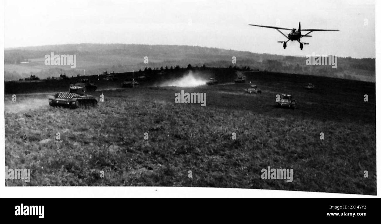 AIRCRAFT PRACTICE TANK SPOTTING - A 'Lysander' aircraft flying low over a number of 'enemy' tanks during an exercise British Army Stock Photo