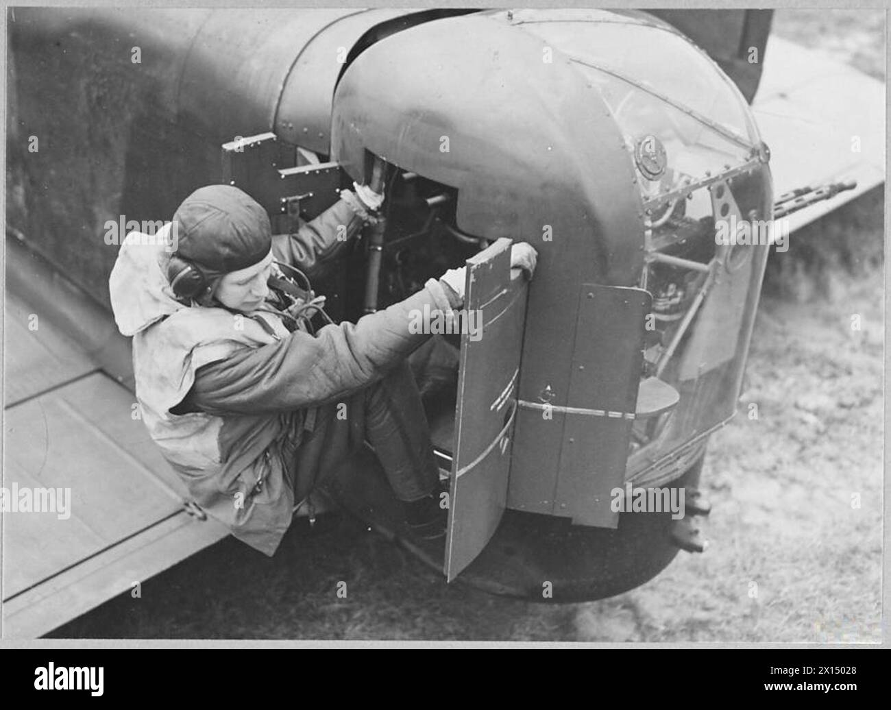 A rear-gunner in the Royal Air Force exits his gun turret after ...