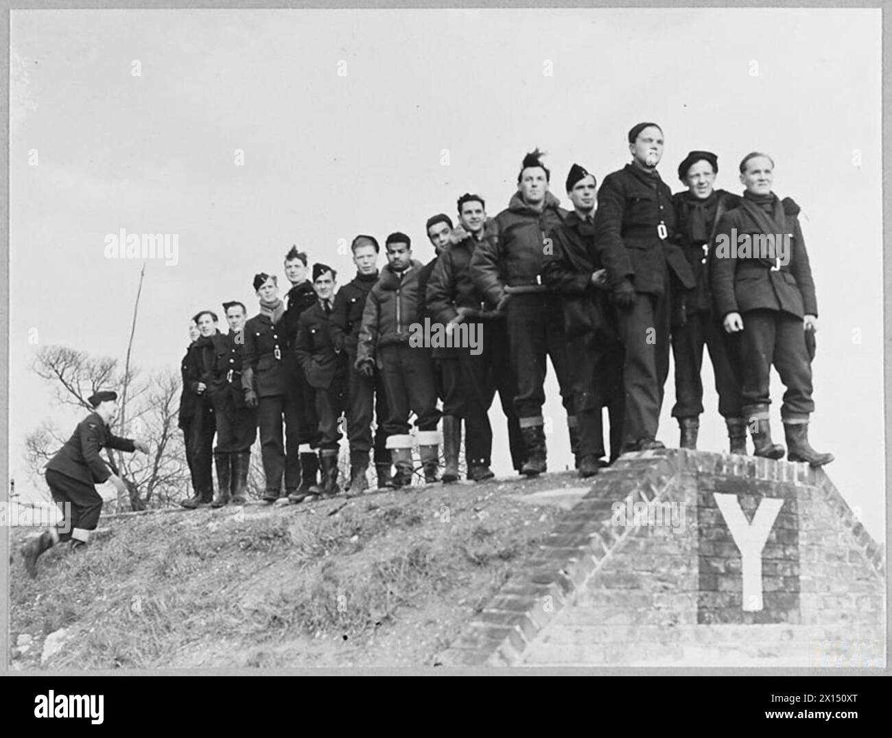 BRITAIN'S ACE FIGHTER PILOT TAKES OVER COMMANDOF A CRACK FIGHTER STATION - 8103 A critical audience of fighter pilots and mechanics watching Spitfires take off on a daylight sweep Royal Air Force Stock Photo
