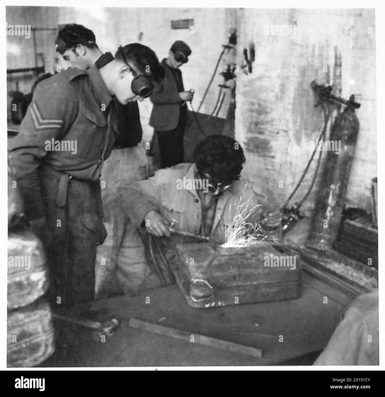 Italian civilians, supervised by a British soldier, repair damaged 4 ...