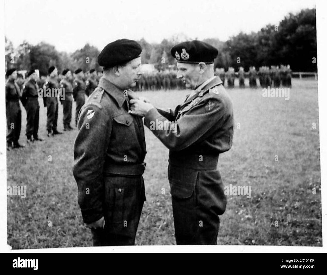 INVESTITURE CEREMONY FOR MEN OF THE 6TH GUARDS ARMOURED BRIGADE - Lieutenant Colonel C.I.H.Dunbar 3rd Tk.Scots Guards receives the D.S.O. from the C-in-C British Army, 21st Army Group Stock Photo