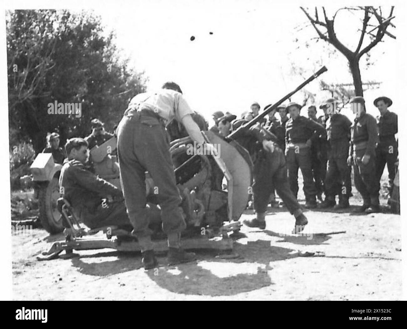 British troops undergo gun drill training on a captured German gun ...