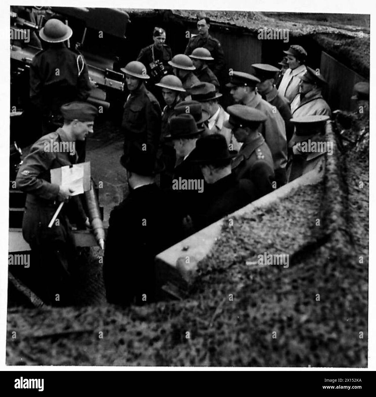 MEMBERS OF PARLIAMENT SEE A.A. DEFENCES - A gun crew show the MPs how