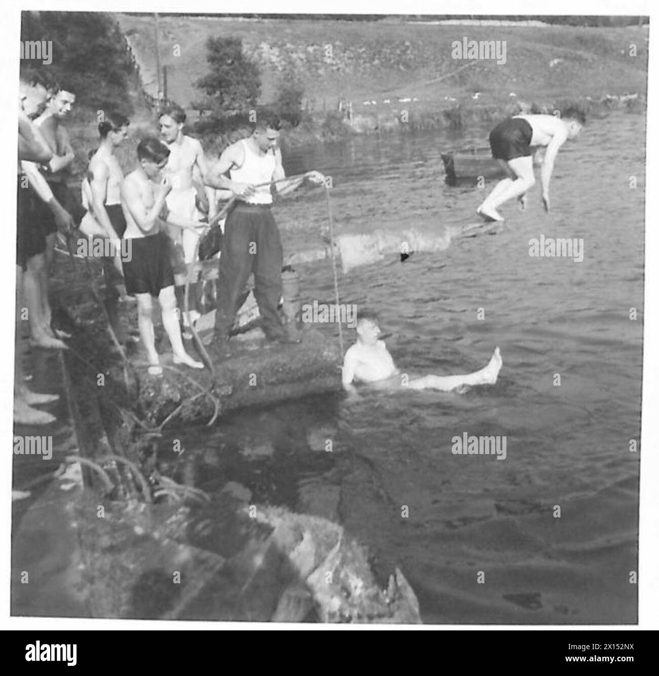 PARACHUTE TRAINING DEPOT & SCHOOL AIRBORNE FORCES - Swimming also forms part of their training. Here non-swimmers are being taught by means of a rope tied round their waists and controlled by an instructor British Army Stock Photo