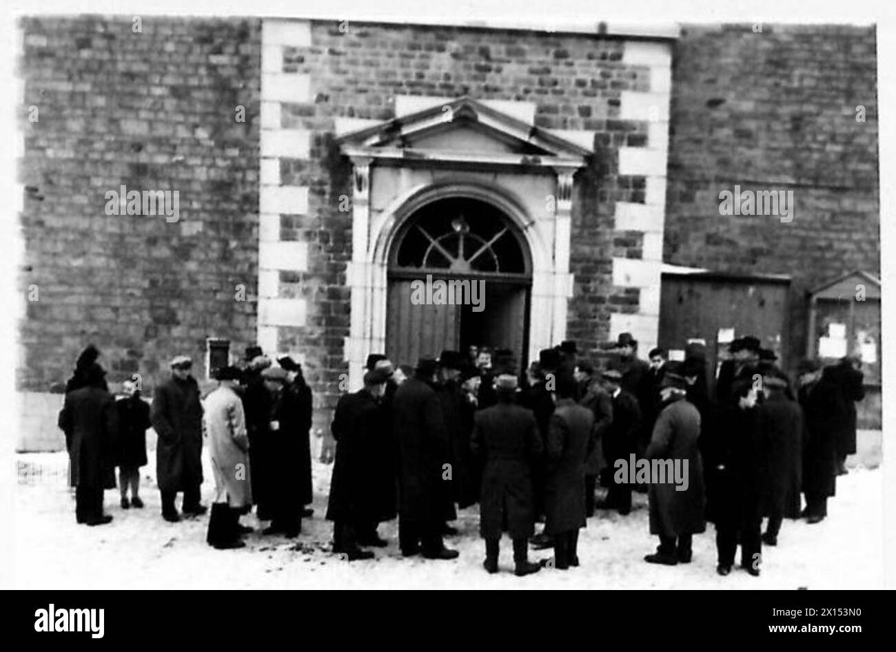BURIAL OF NAZIS' VICTIMS - Heartbroken parents coming out of the church British Army, 21st Army Group Stock Photo