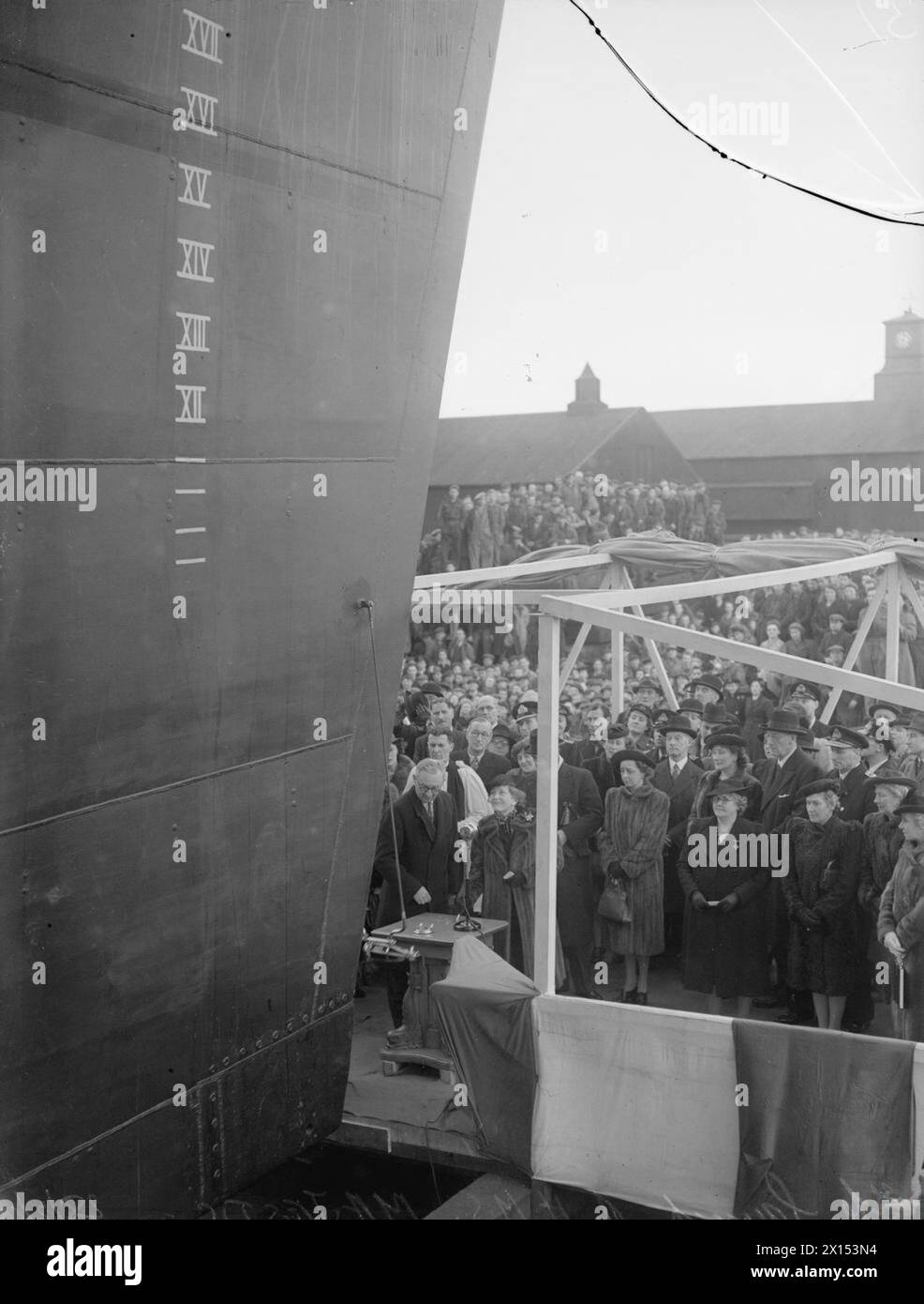 LAUNCH OF THE MAJESTIC. 28 FEBRUARY 1945, VICKERS-ARMSTRONG LTD, BARROW-IN-FURNESS. THE LAUNCH OF THE AIRCRAFT CARRIER HMS MAJESTIC BY LADY ANDERSON, WIFE OF THE RT HON SIR JOHN ANDERSON. - Lady Anderson names the carrier Stock Photo