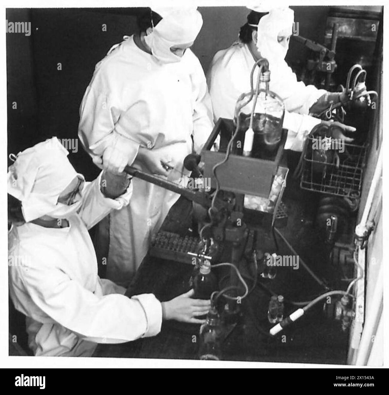 Group 'O' blood is stored in small banks for emergencies. Sugar solution is added to prolong red blood cell life, allowing storage for 2–3 weeks at 2–4°C. Sgt. Lockyear, Ptes. Webb and Lumley, ATS, handle the process. Stock Photo