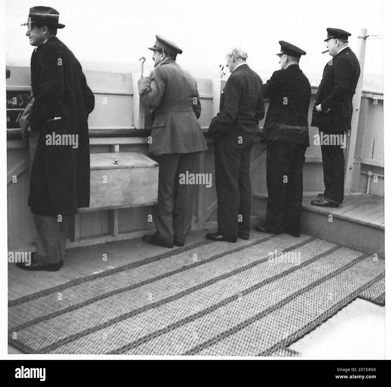 MR. CHURCHILL ARRIVES IN CANADA - Mr. Harrison, General Sir Alan Brooke, Lord Moran, Admiral Sir Dudley Pound and the Prime Minister, watching the ship berth on arrival in Canada British Army Stock Photo