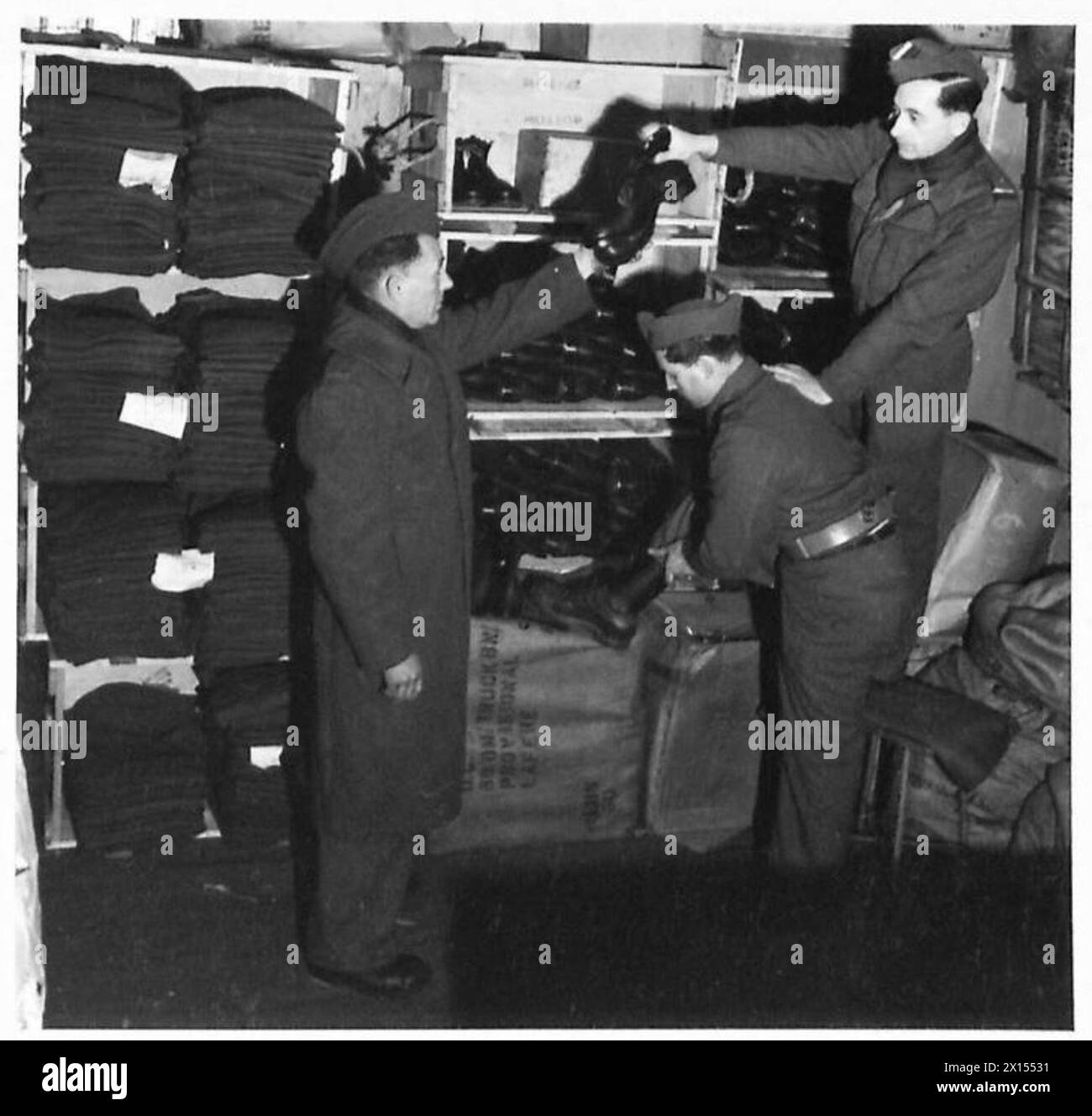 BRITISH UNIFORMS FOR FRENCH ARMY - The quartermaster issuing British boots , British Army, 21st Army Group Stock Photo