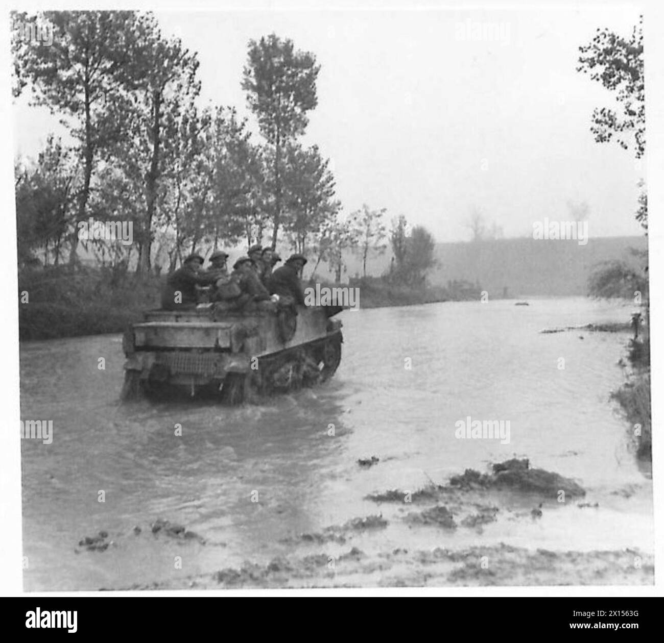 Infantry in Bren carriers of the Eighth Army cross the River Rabbi at S. Martino, southwest of Forli, during operations in Italy. Stock Photo
