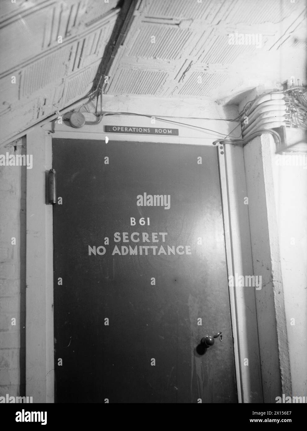 FILMING ATLANTIC BATTLE OPERATIONS ROOM. 26 AND 27 SEPTEMBER 1944, DERBY HOUSE, LIVERPOOL. SCENES FOR AN ANGLO-AMERICAN OFFICIAL FILM COVERING THE BATTLE OF THE ATLANTIC RIGHT UP TO D-DAY, BEING SHOT BY ARMY FILM UNIT CAMERAMEN AT THE HEADQUARTERS OF THE C IN C WESTERN APPROACHES. - The entrance to the Operations room Royal Navy, Western Approaches Command Stock Photo