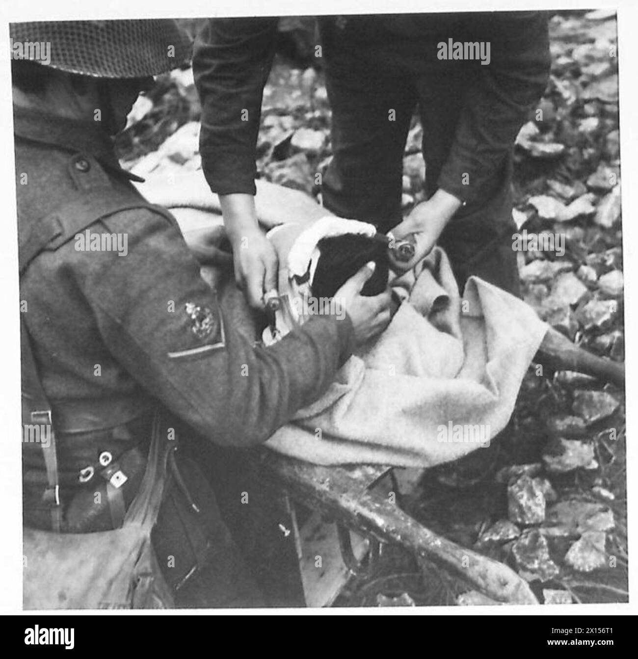 A soldier in North Africa receives a new dressing as part of first aid ...