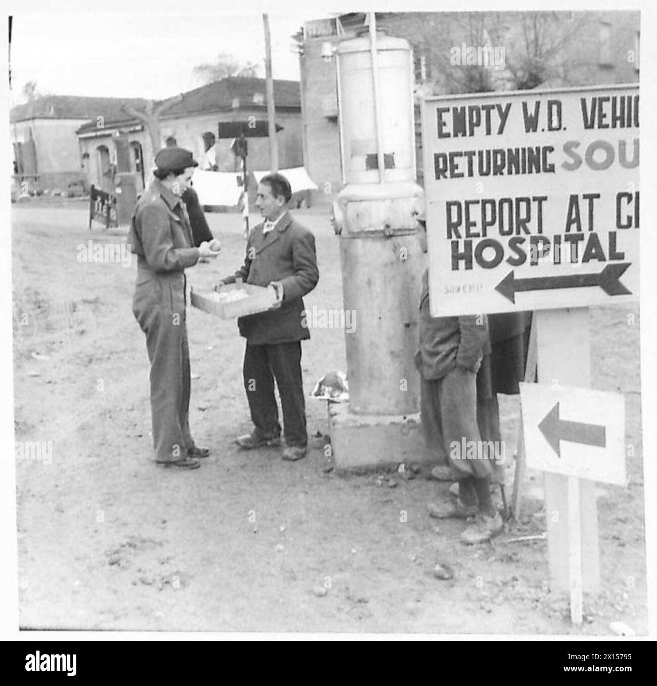 Sister Gibson, a front line nurse with the British Eighth Army in Italy, is shown purchasing fruit from a local Italian vendor for soldiers. Stock Photo
