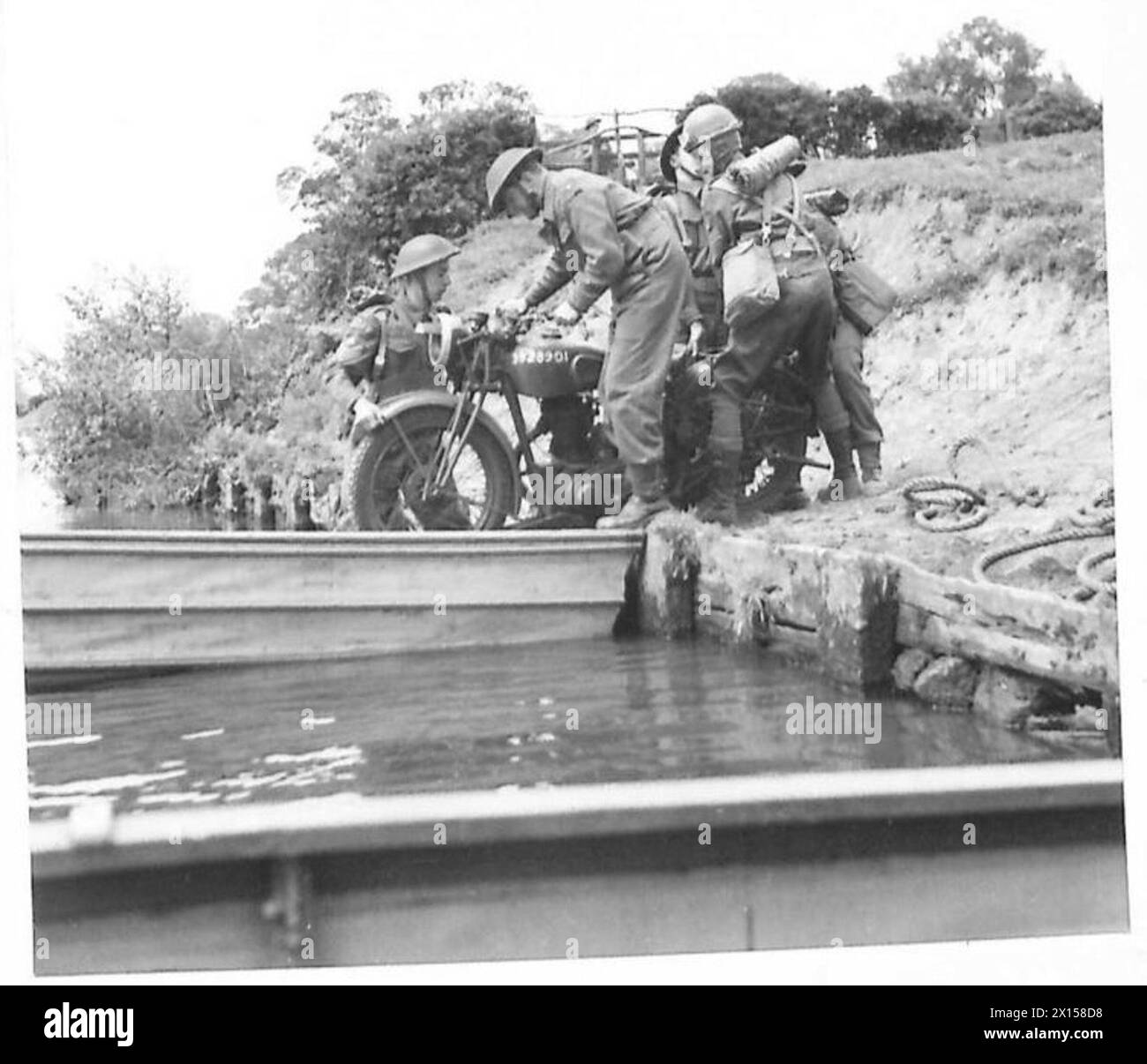 A despatch rider prepares to cross a river using a collapsible assault ...