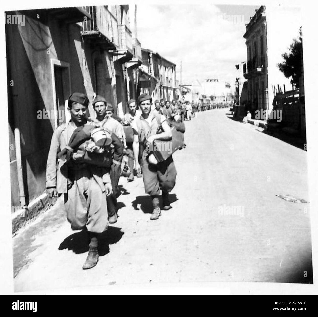 Italian prisoners of war march in single file along roads north of ...