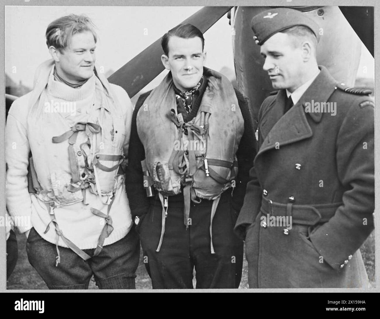 BRITAIN'S ACE FIGHTER PILOT TAKES OVER COMMANDOF A CRACK FIGHTER STATION - 8103 Group Captain A.C. Malan, with two of the fighter pilots before they took off on a daylight sweep. The pilot in the centre is S/Ldr. Hugo Armstrong, DFC., whose home is in West Perth, Australia Royal Air Force Stock Photo