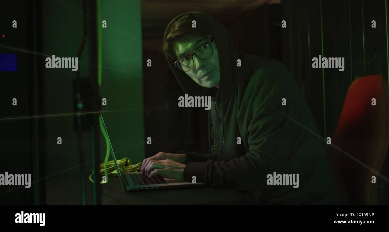Image of data processing over asian male hacker in server room Stock Photo
